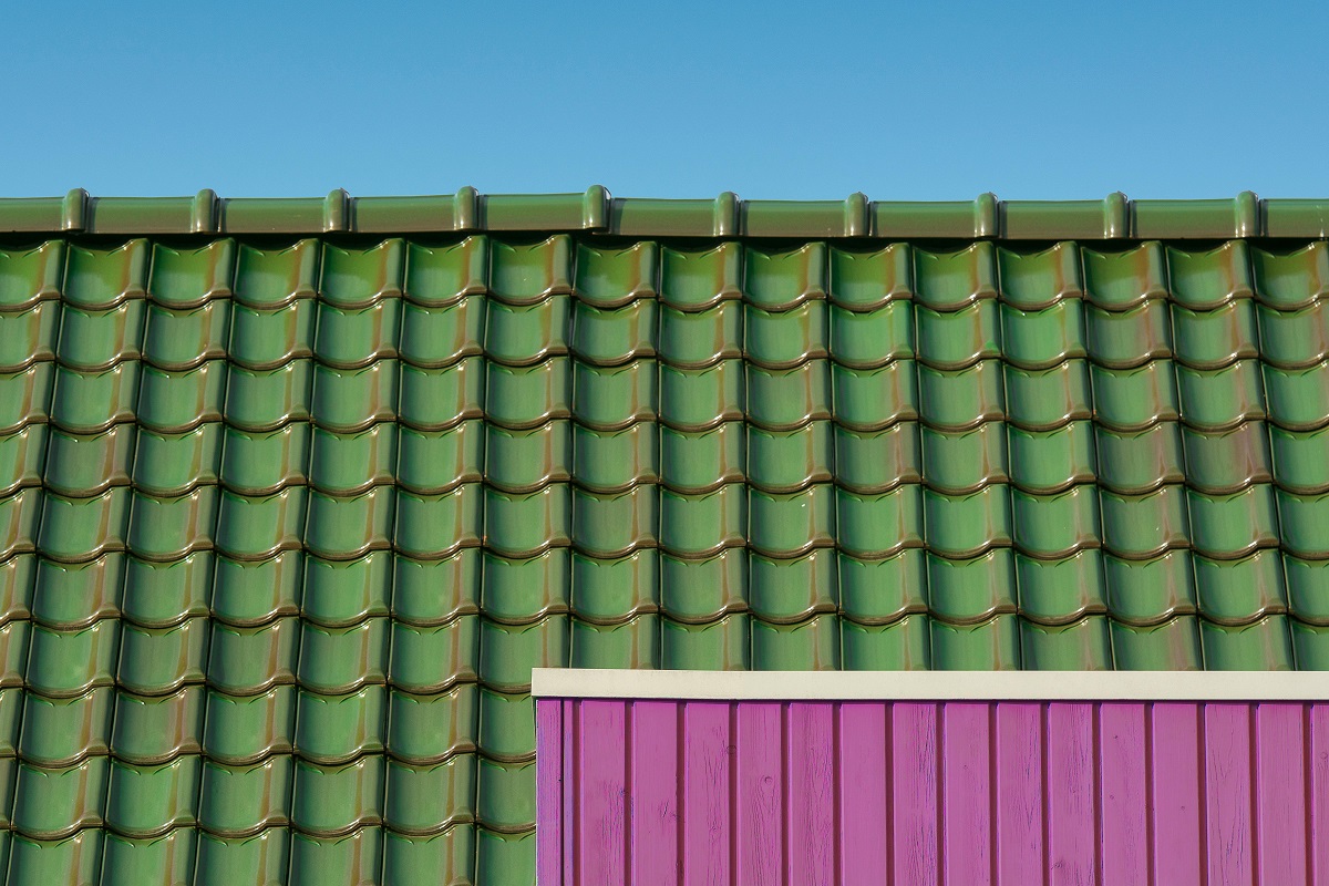 green aluminum roof under clear skies